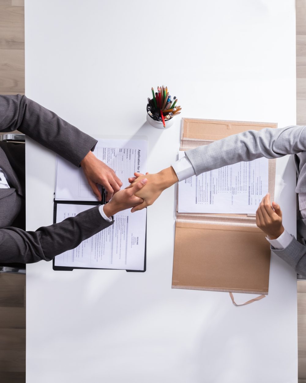 Male Manager Shaking Hands With Female Applicant